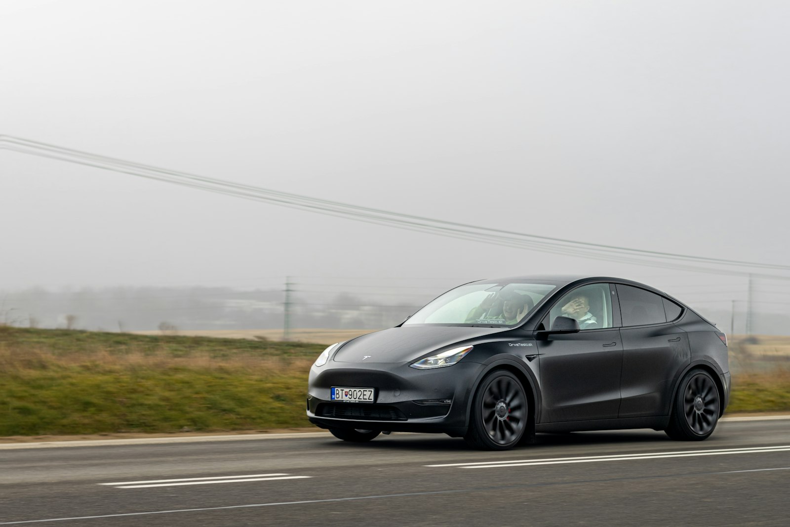Tesla Model Y driving on a country road
